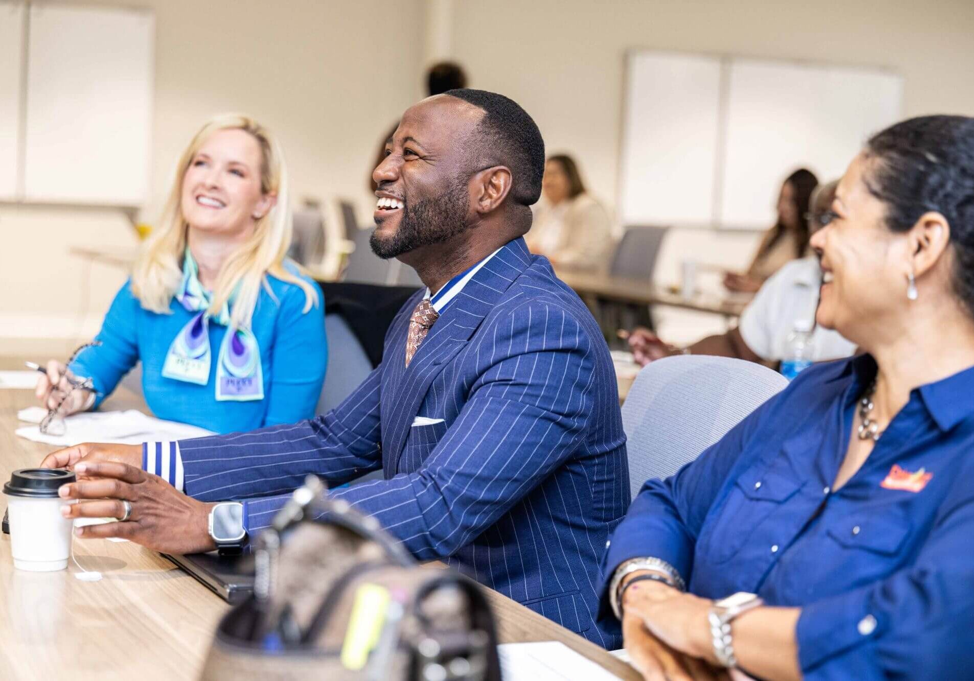 Attendees laughing together at a table during a Chamber event