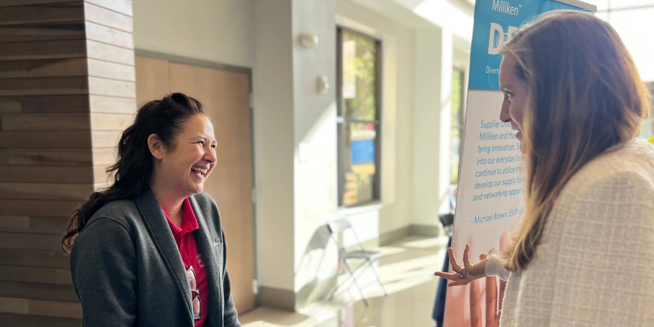Attendees talking in a hallway at an event