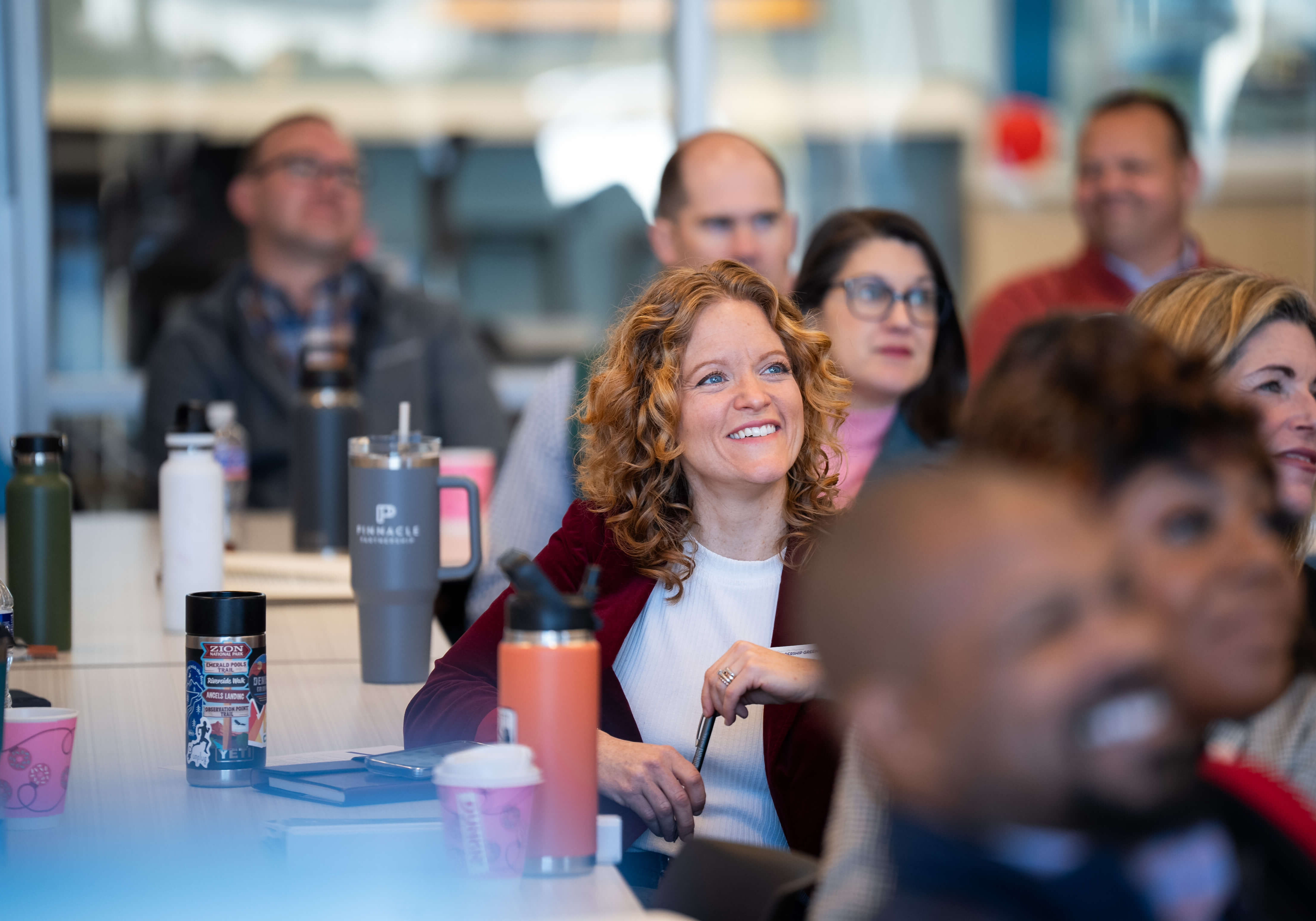 Program participants smiling while seated in an audience